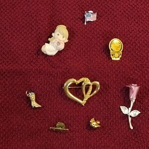 Assorted Brooch and Pin Set on Red Fabric